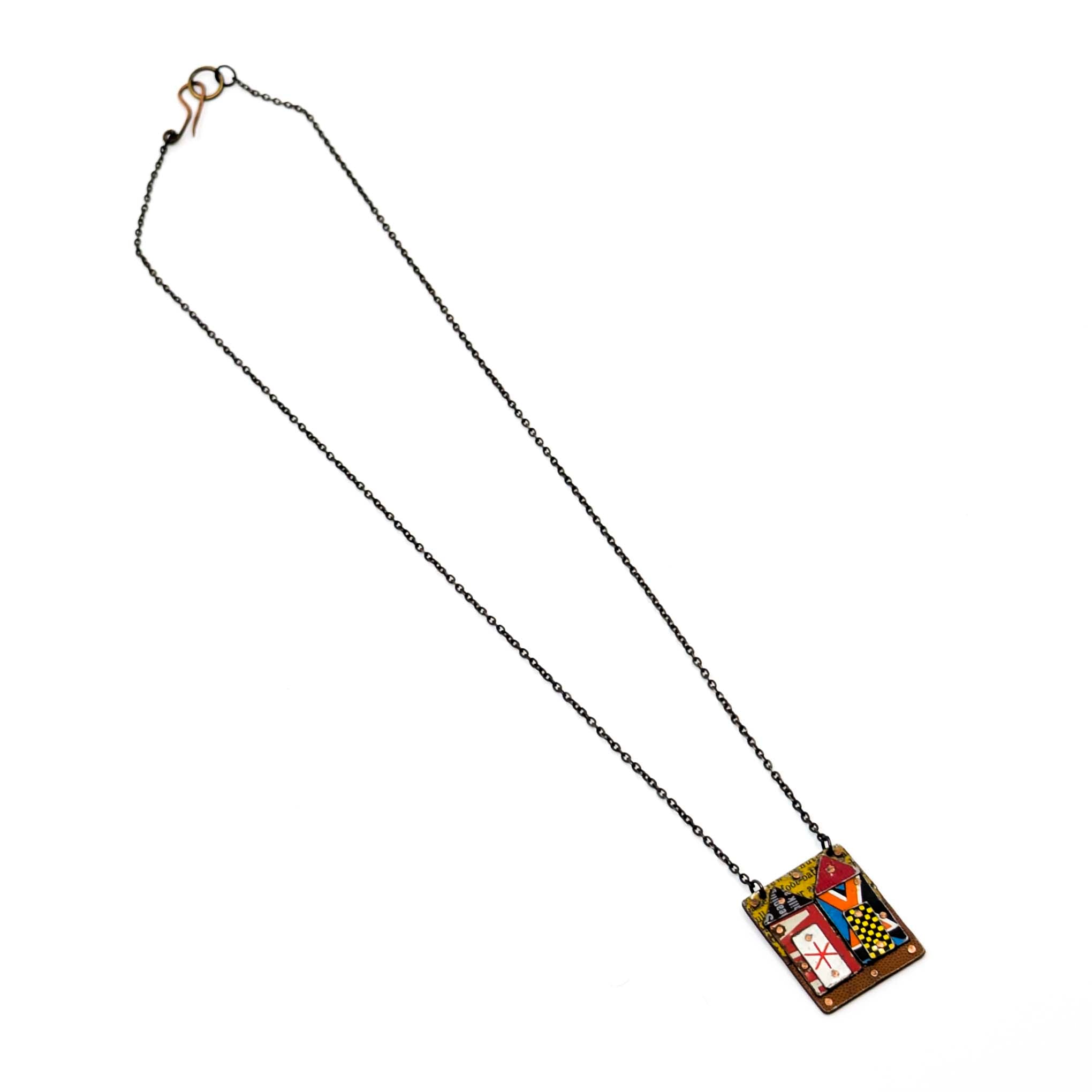 Necklace with a pendant featuring a colorful abstract house on a white background