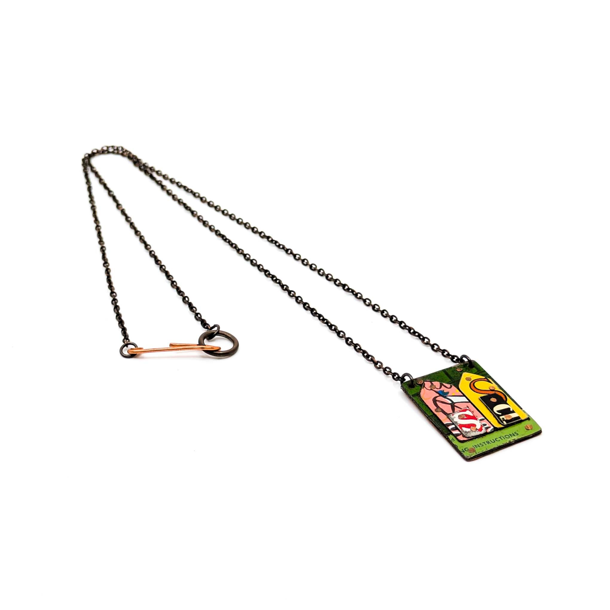 Necklace with a pendant featuring a colorful abstract house on a white background