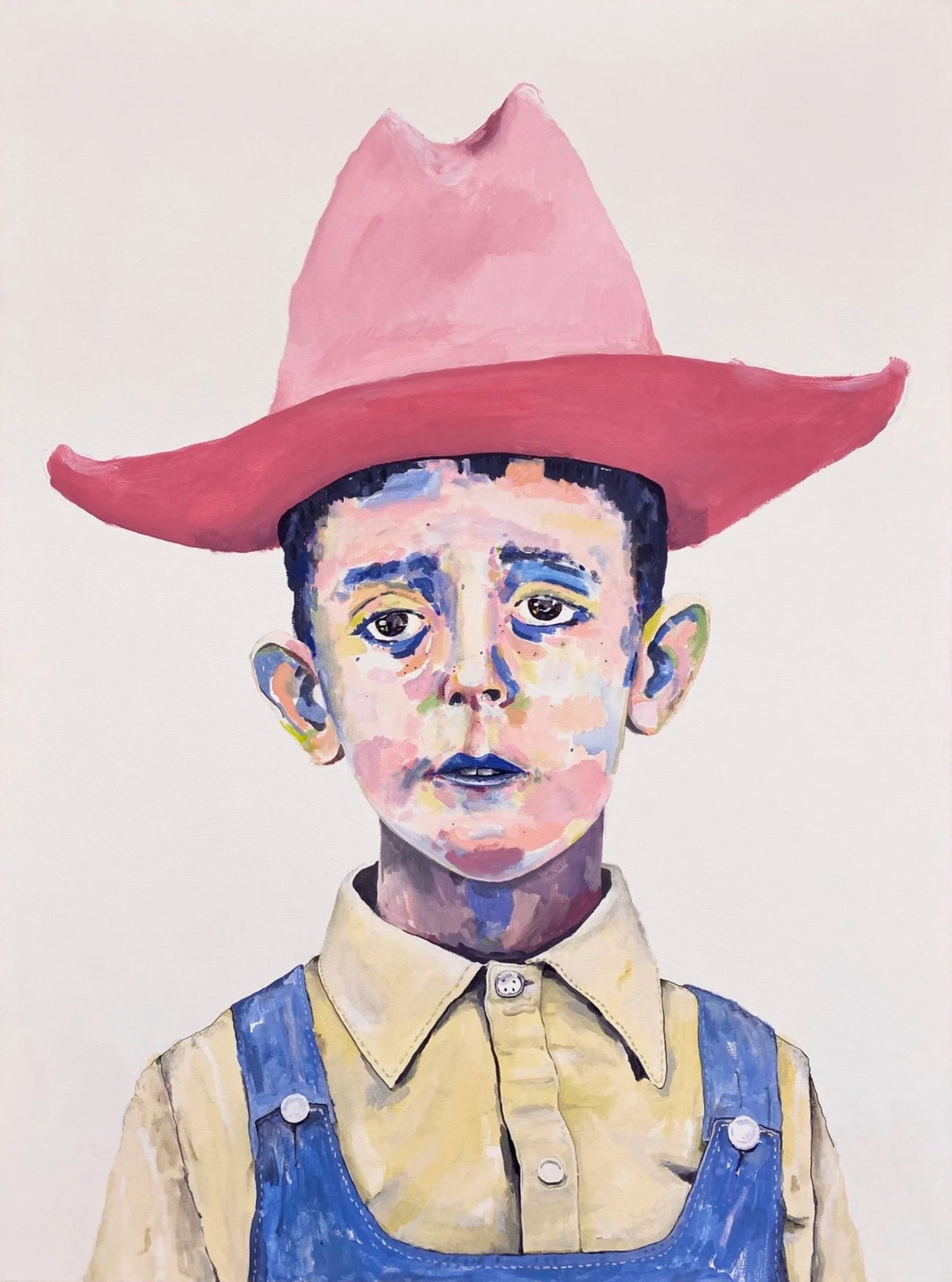 Boy in a red cowboy hat with white background
