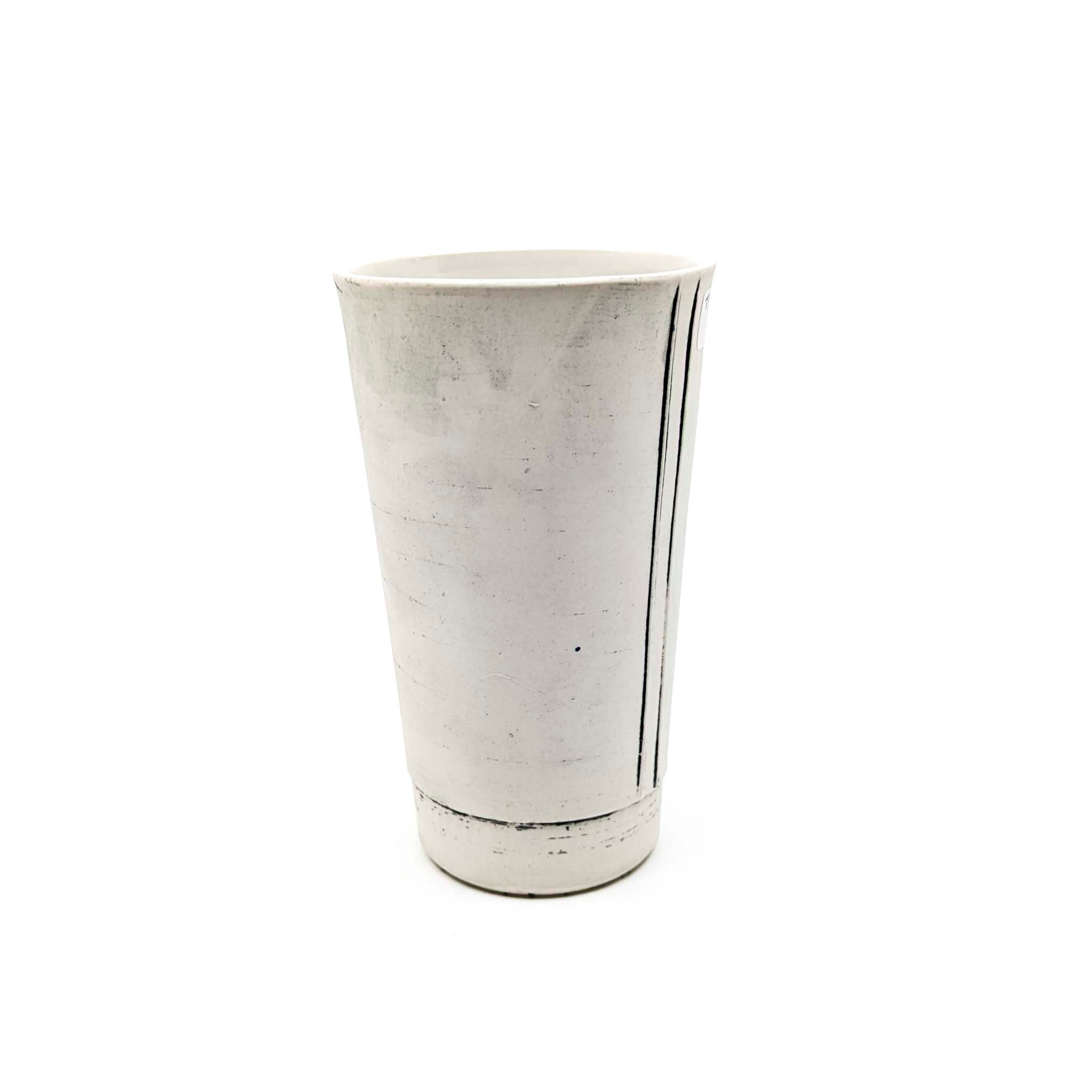 White ceramic tumbler on a white background